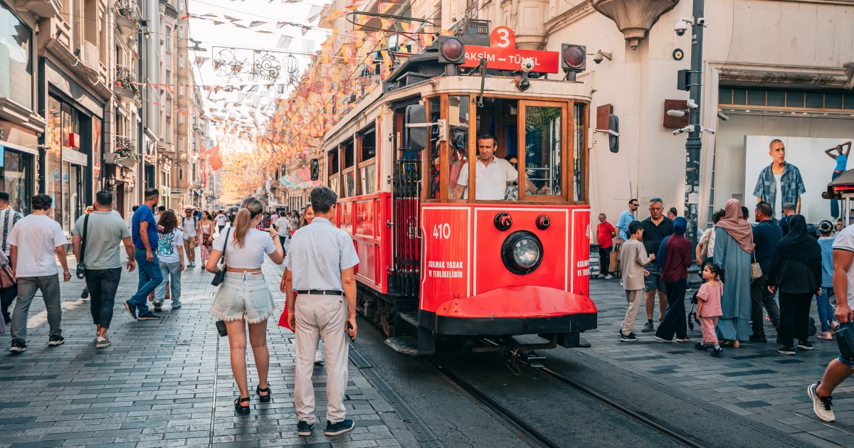 Istanbul tram and visitors on Istiklal Avenue